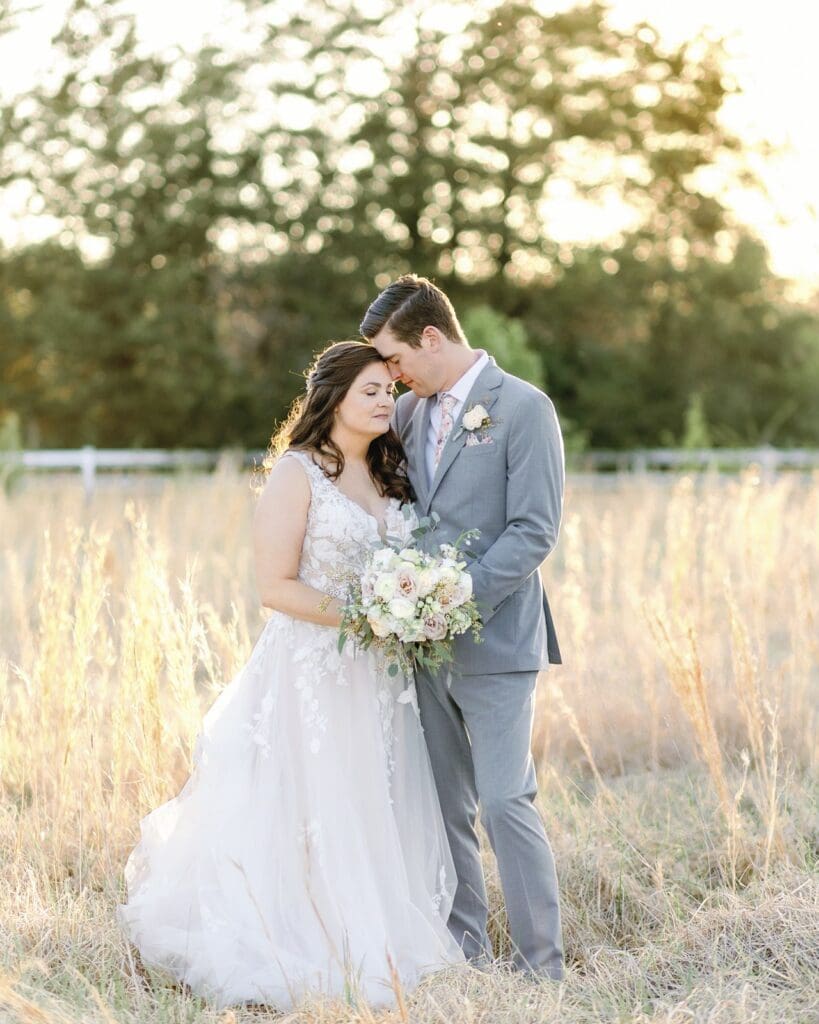 A tender moment shared by a bride and groom during sunset