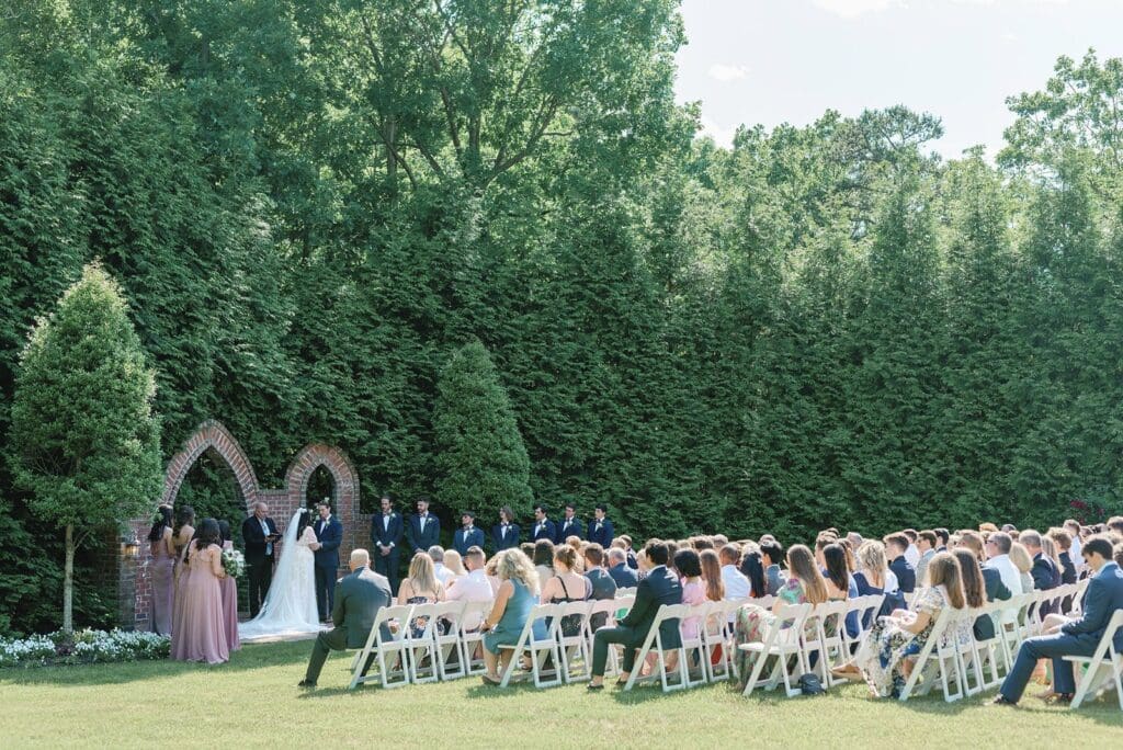 Spring wedding ceremony surrounded by green trees